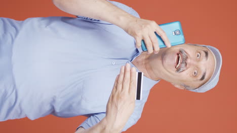 Vertical-video-of-Old-man-shopping-with-credit-card.